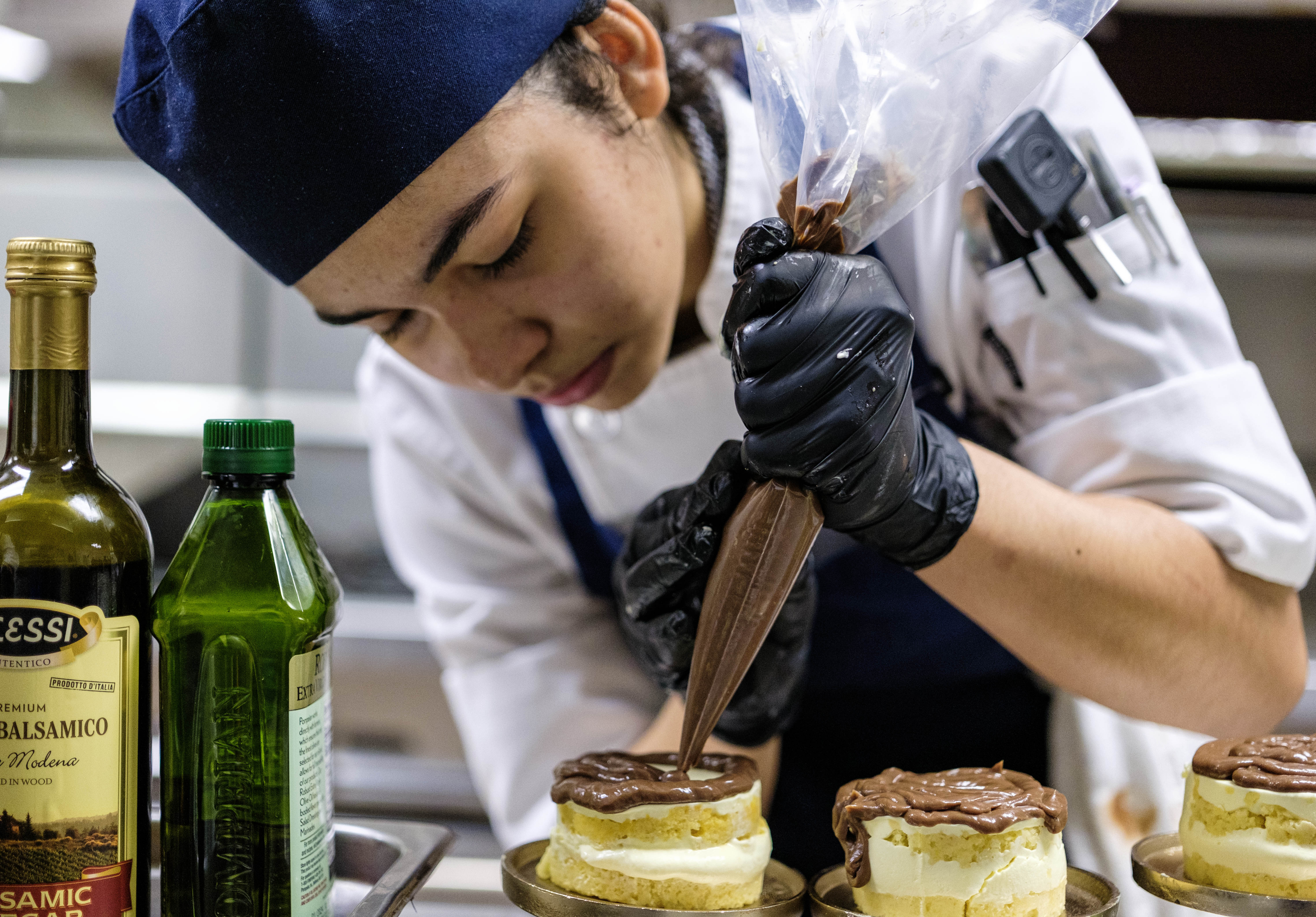 Culinary Arts student decorates a pastry