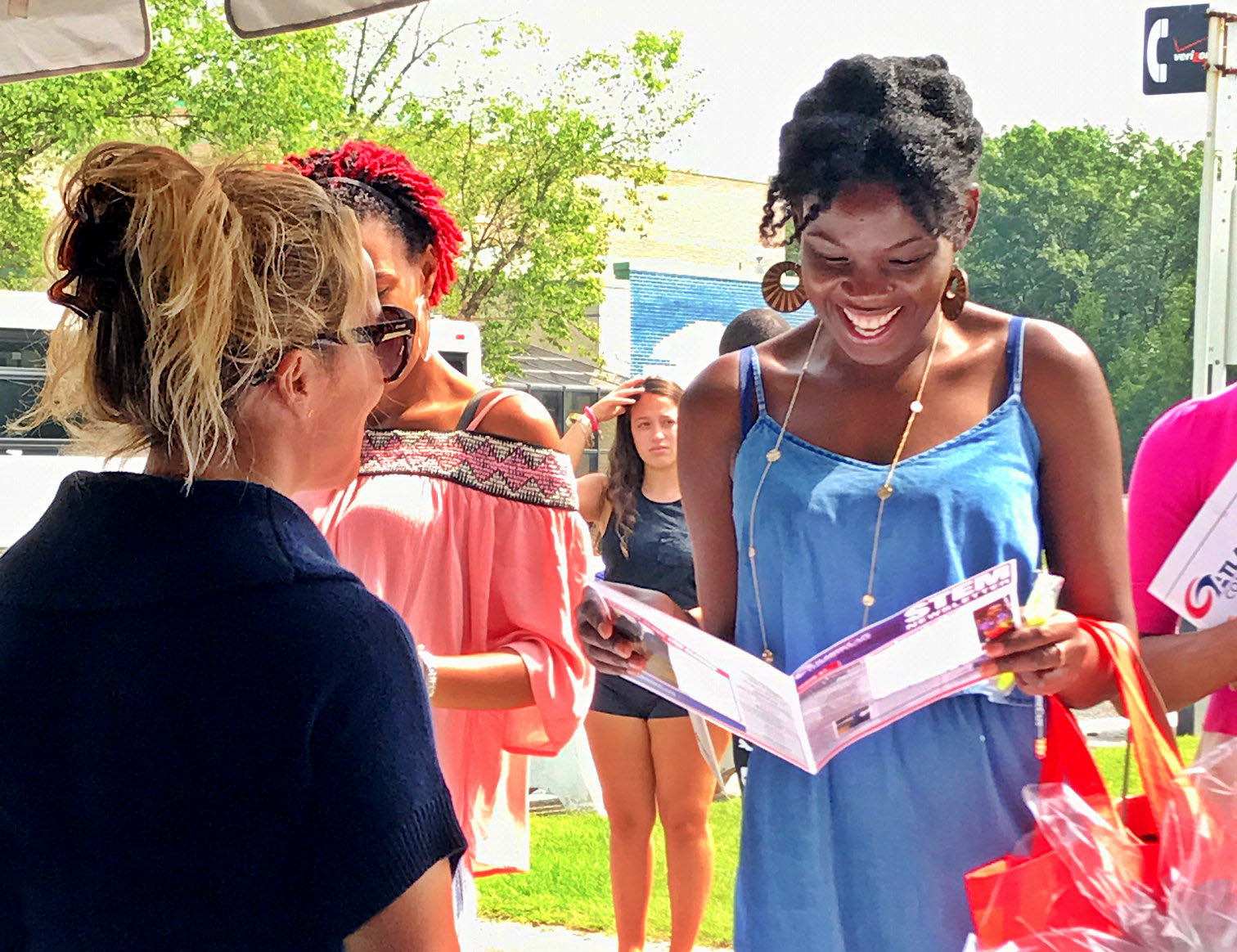 Prospective student reading a pamphlet on college campus