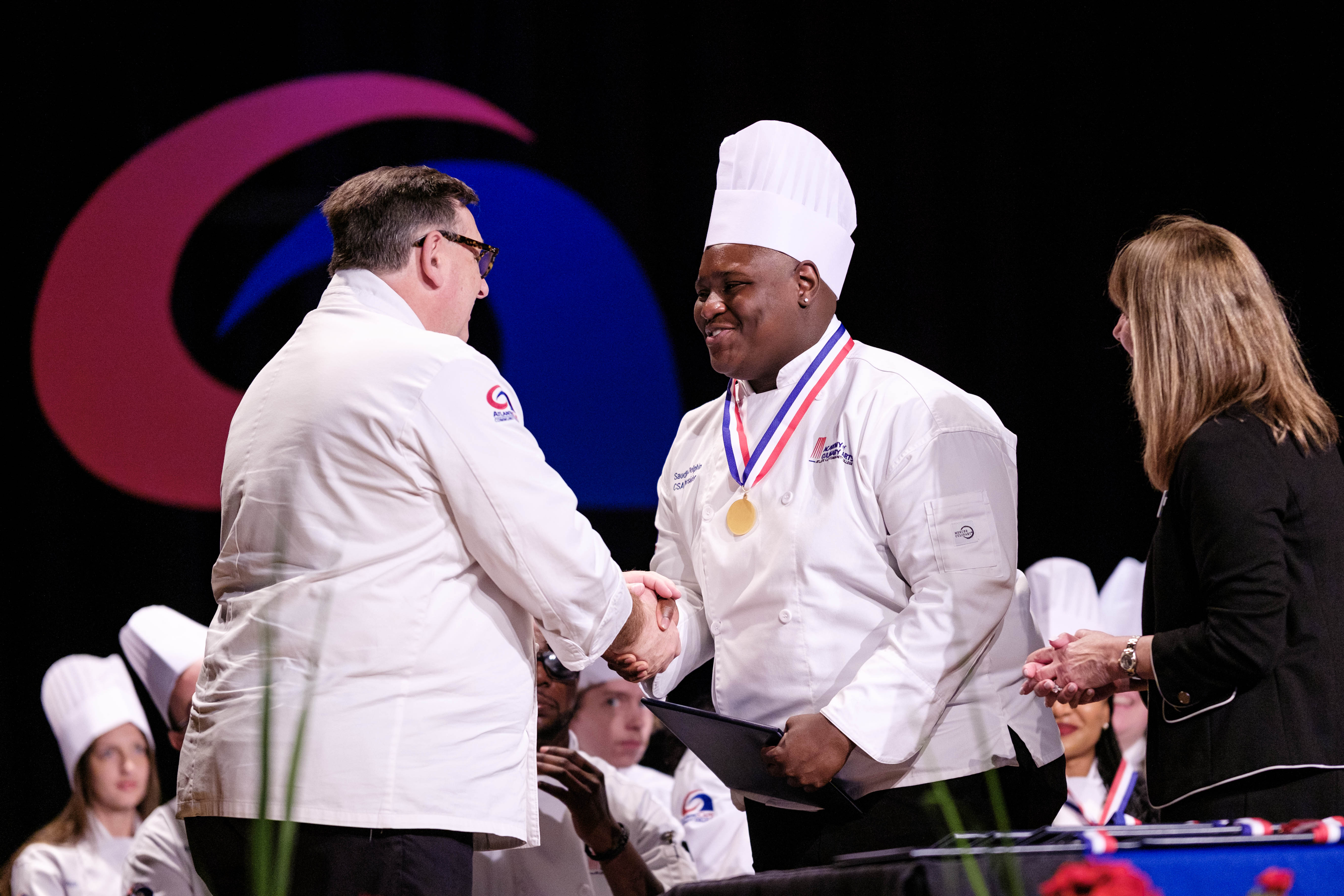 Chef Joe Sheridan presents to graduate Saudly Delphin