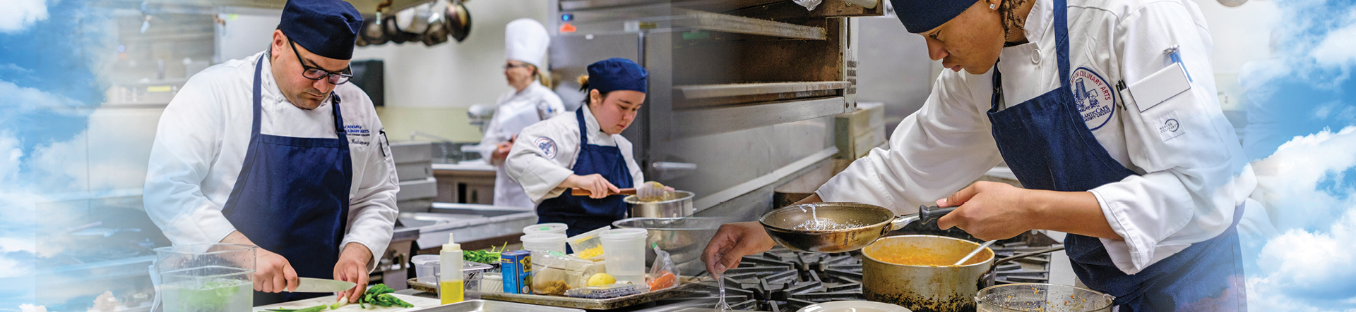 Culinary students preparing food on pots and pans.