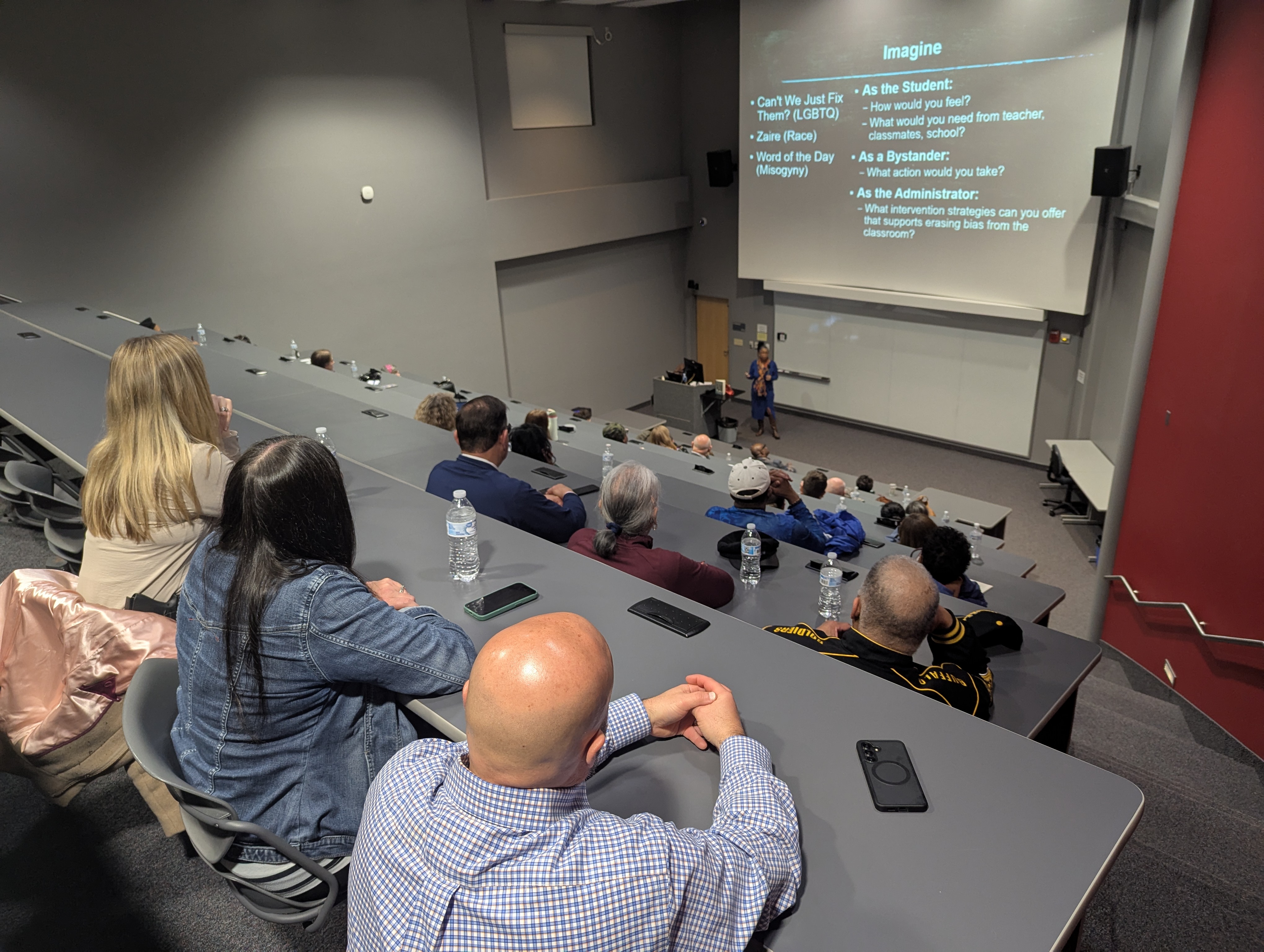 Audience in lecture hall listens to presentation