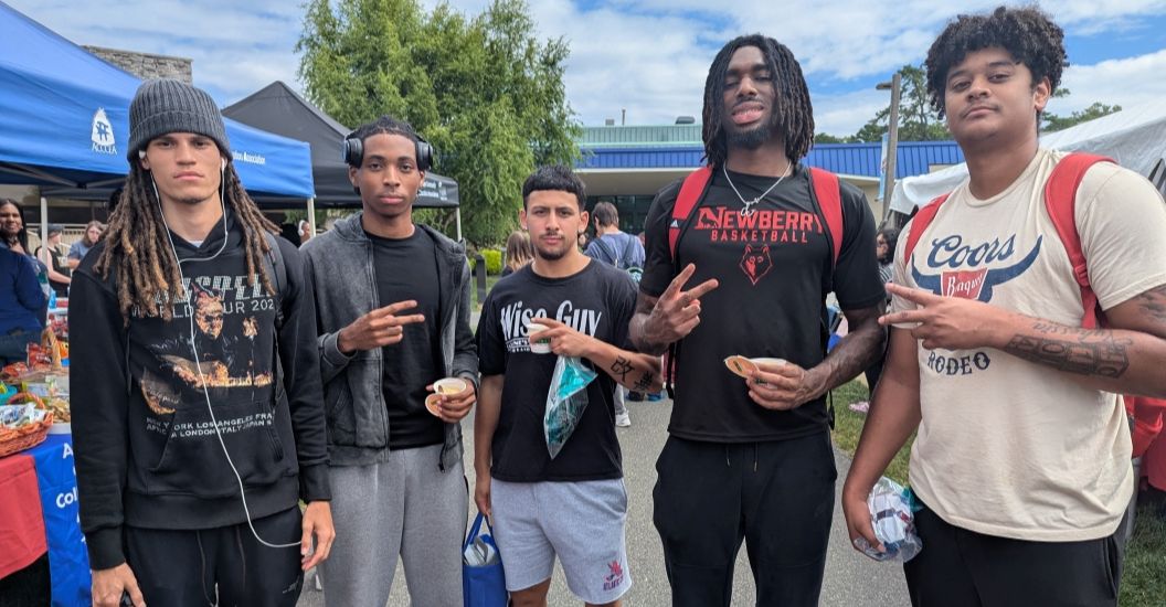 Five men's basketball players enjoying Welcome Back event