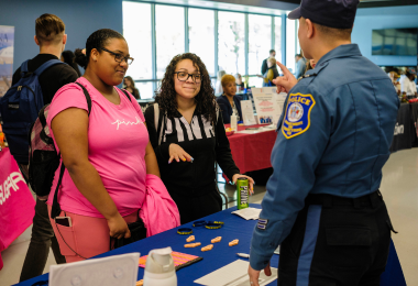 Atlantic Cape students Juliet Mayes and Diana Nambo speak with a representative from the NJ Department of Corrections