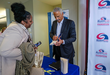 Stedman Graham signs a copy of his book for an attendee