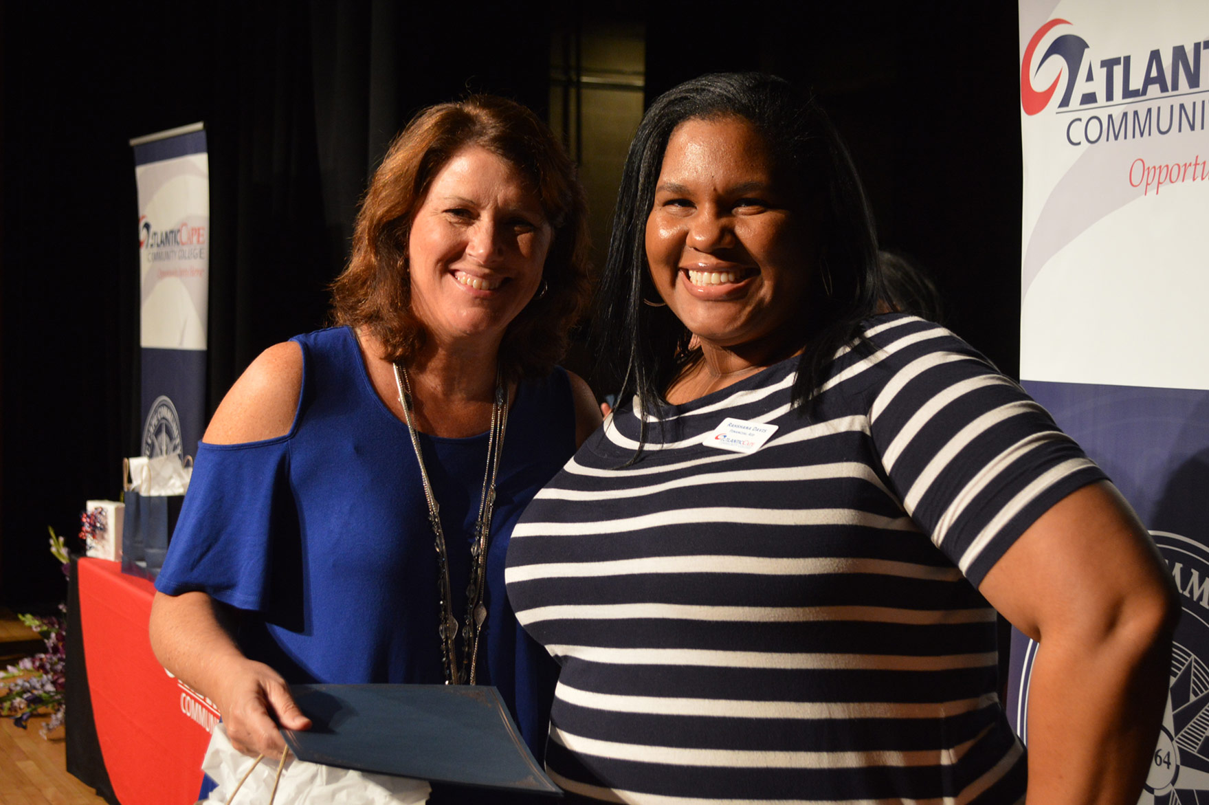 two female staff members at employee recognition ceremony