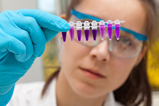 A nurse examines different samples in a lab