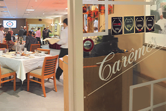 Carême's logo on the front door of the restaurant