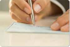 hands signing a check