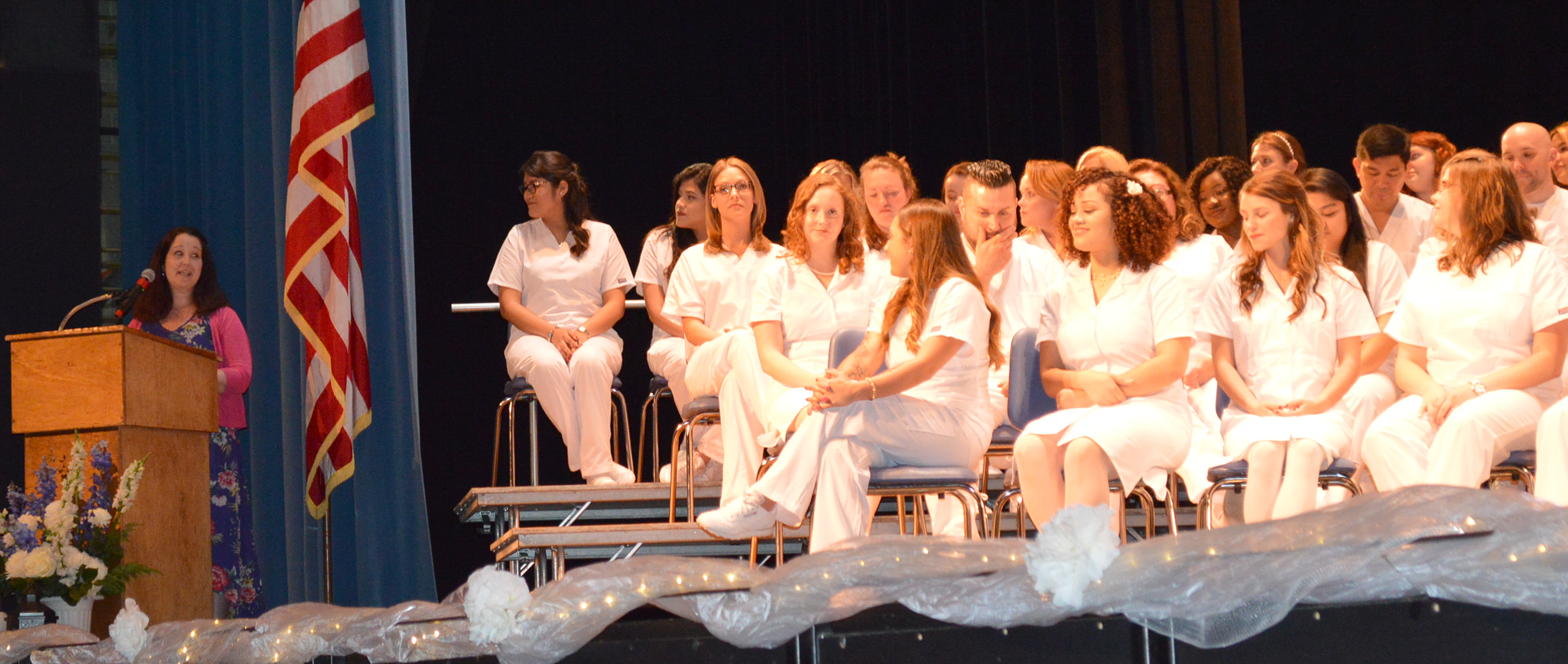 woman at podium addresses nursing class