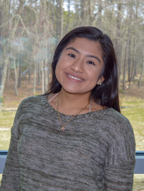girl smiling in front of window