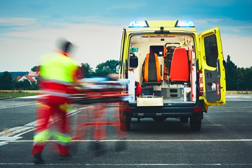 paramedic rushing man on gurney to ambulance