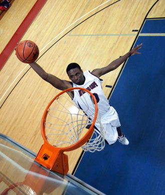 man shooting a basketball hoop