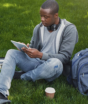 Student outside with tablet