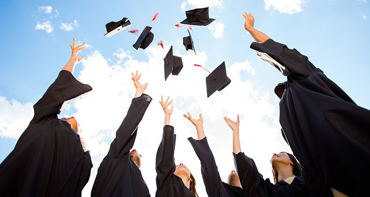 graduates tossing their caps in the air