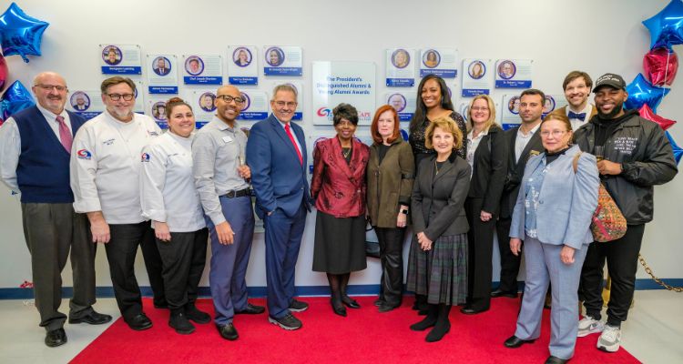 Members of Atlantic Cape's Distinguished and Young Alumni take part in the unveiling of the Wall of Honor