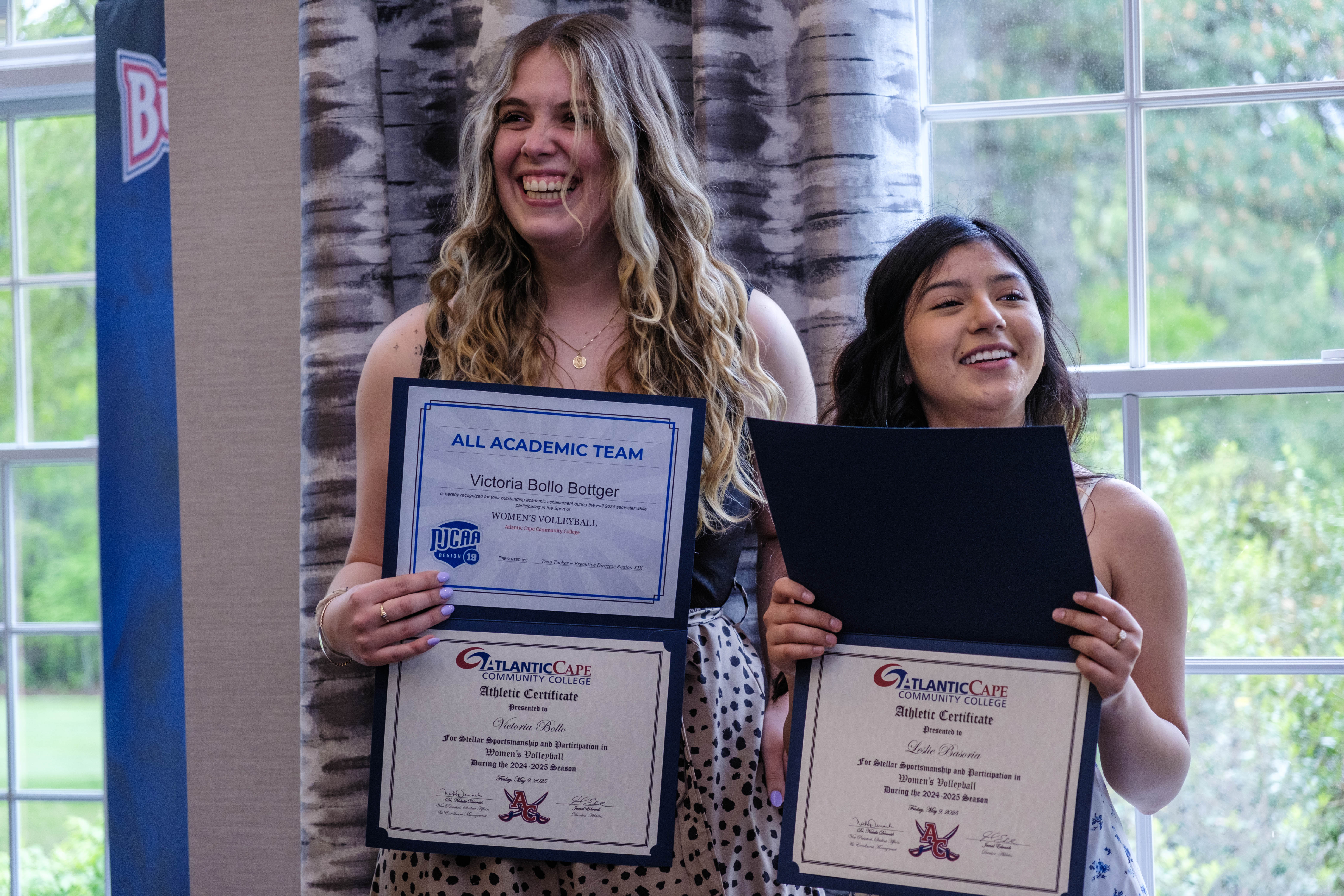Victoria Bollo is all smiles as she receives her certificate