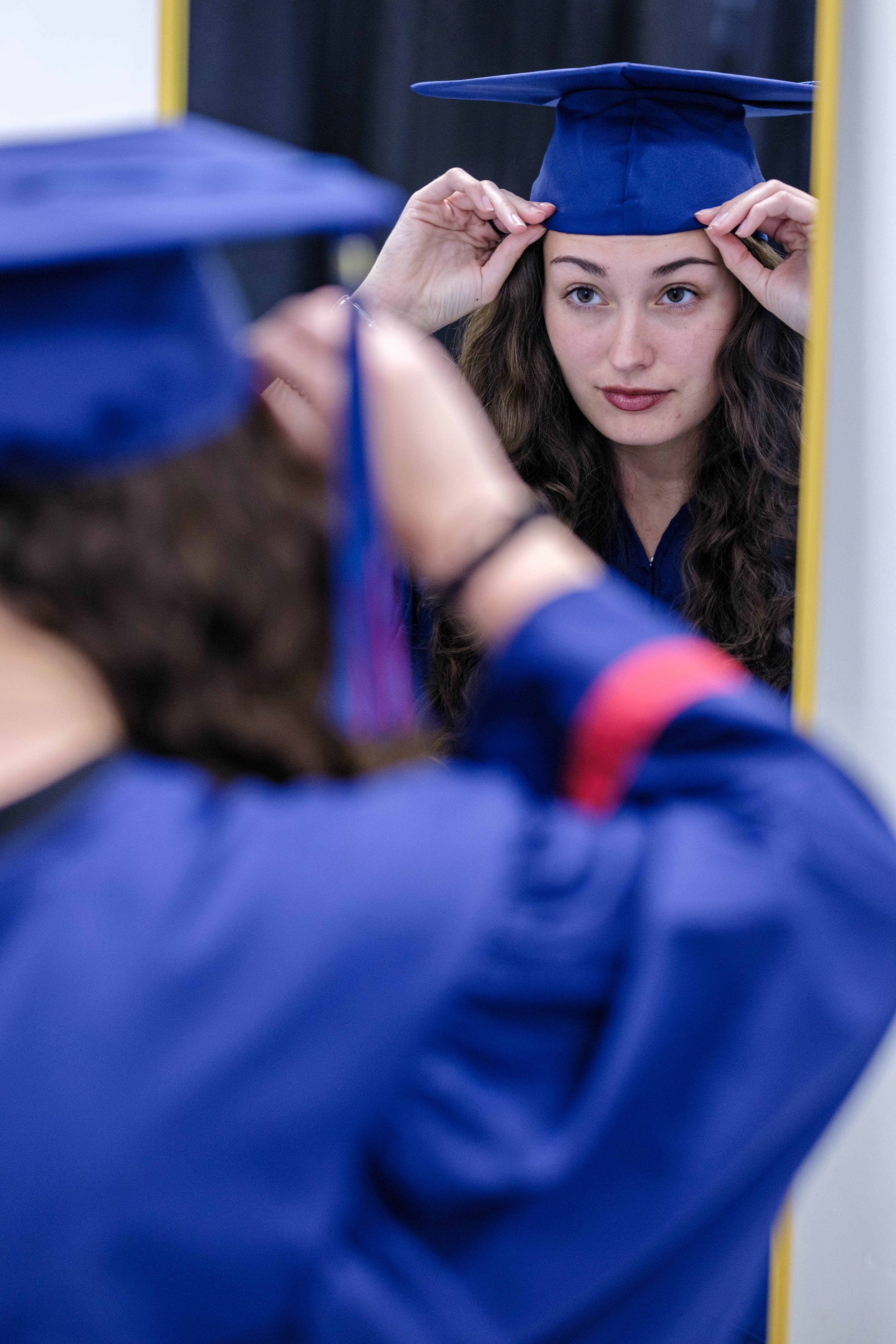 Grad tries on her cap