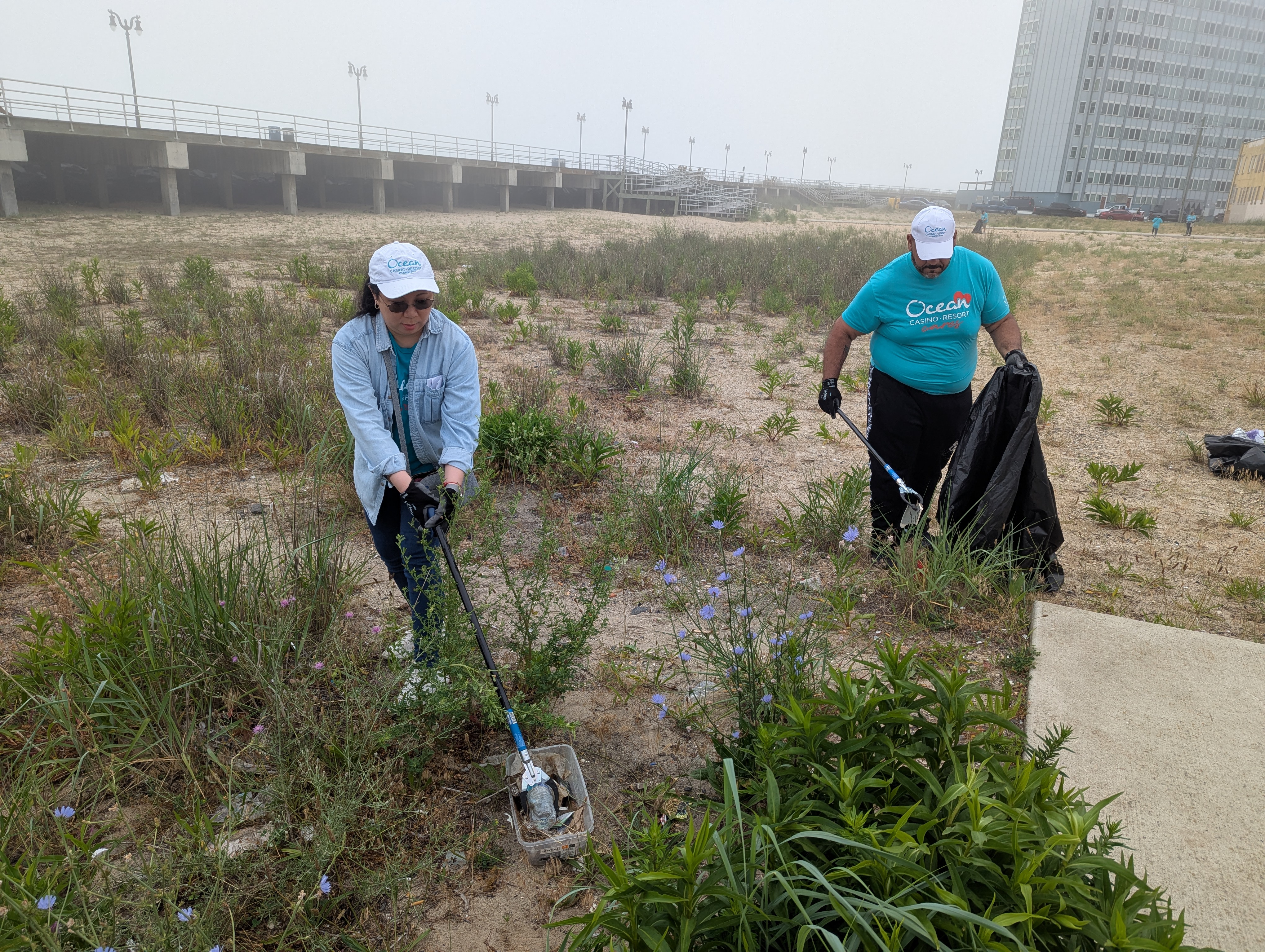 Carmelo Maysont and Karen Hober picking up debris