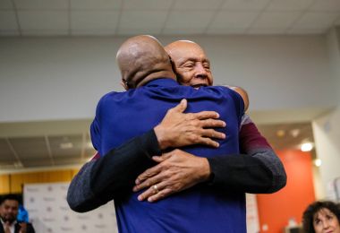 Bobby Royal Sr and Allen Ragland share an embrace
