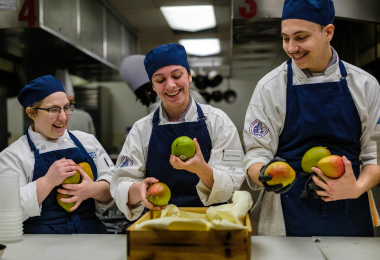 Culinary students enjoy a laugh during the Iron Student competition