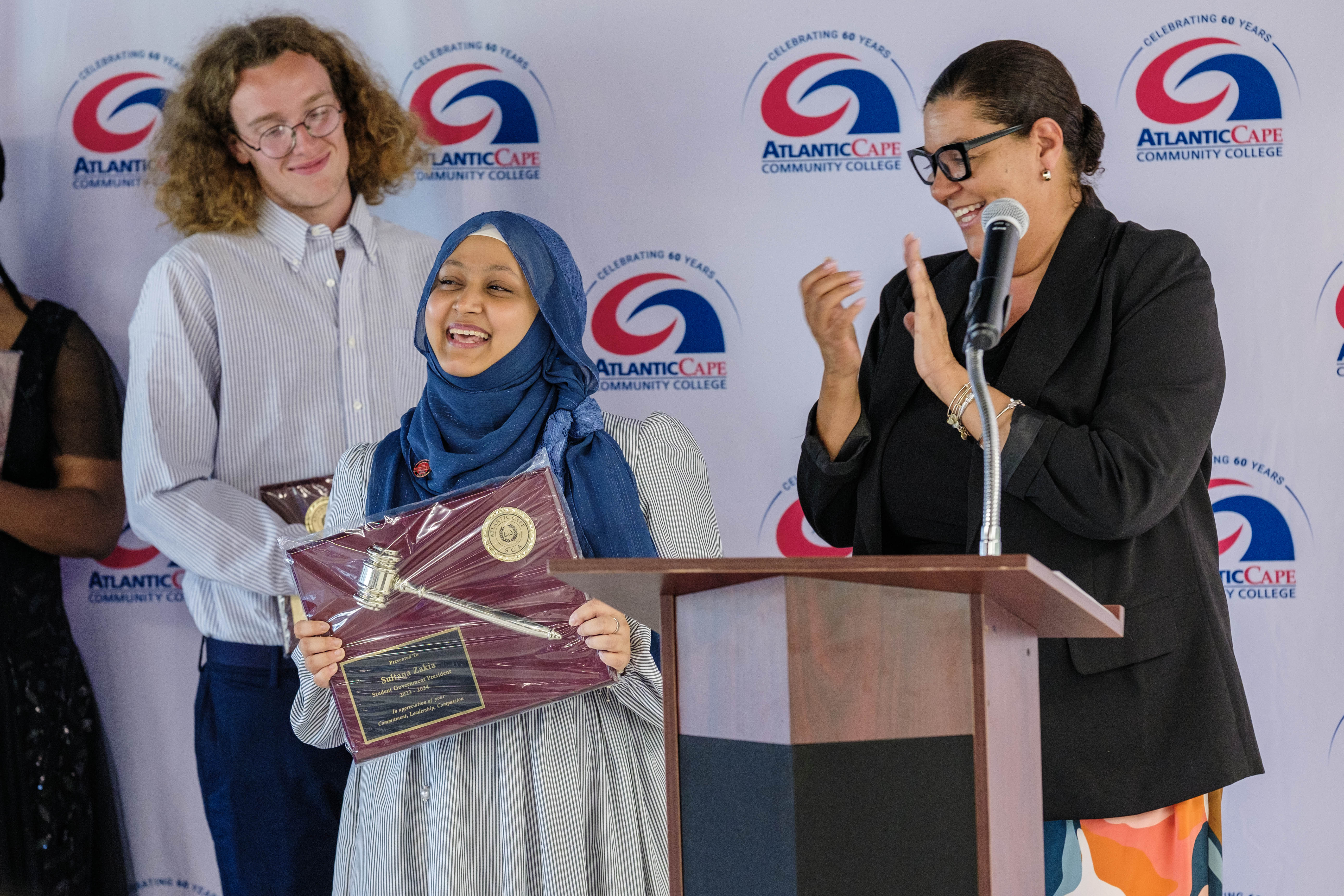 Lisa Givens presents an award to outgoing SGA President Sultana Zakia