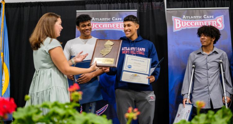 Atlantic Cape's Men's Volleyball team accepts its GSAC Division III champions plaque